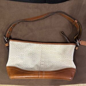 Coach, cream colored shoulder bag with tan leather details